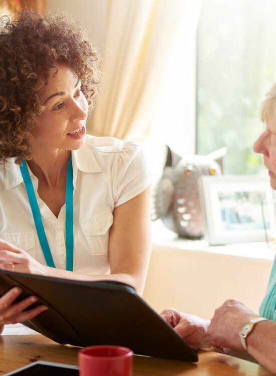 care worker discussing home treatment options and planning with senior woman